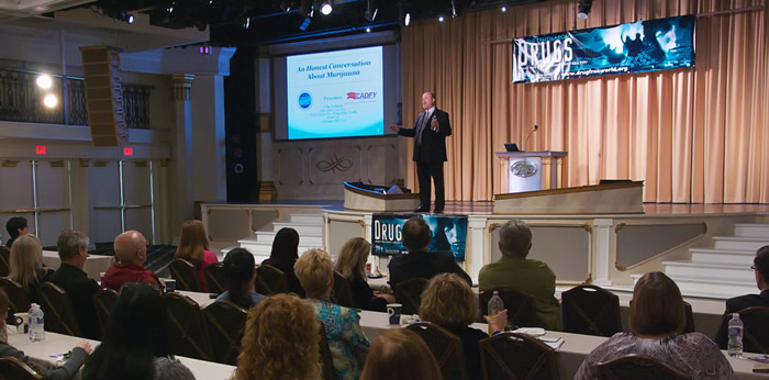 John Redman on stage at the Drug Summit in Clearwater